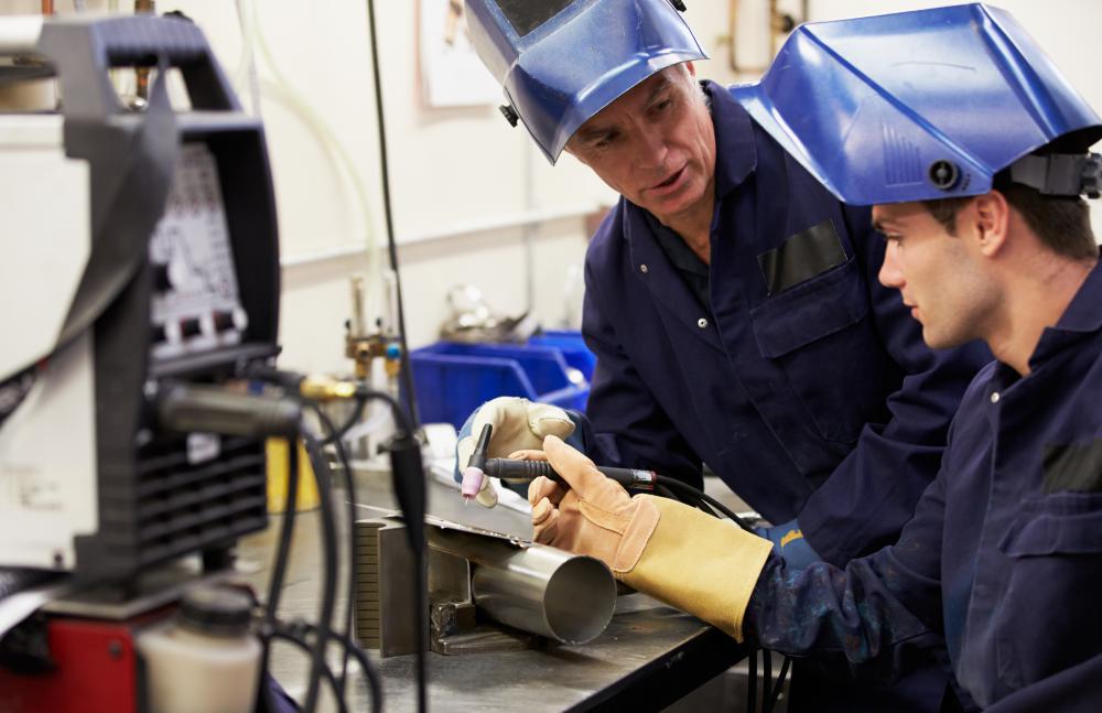 senior-worker-showing-young-man-how-to-weld.jpg